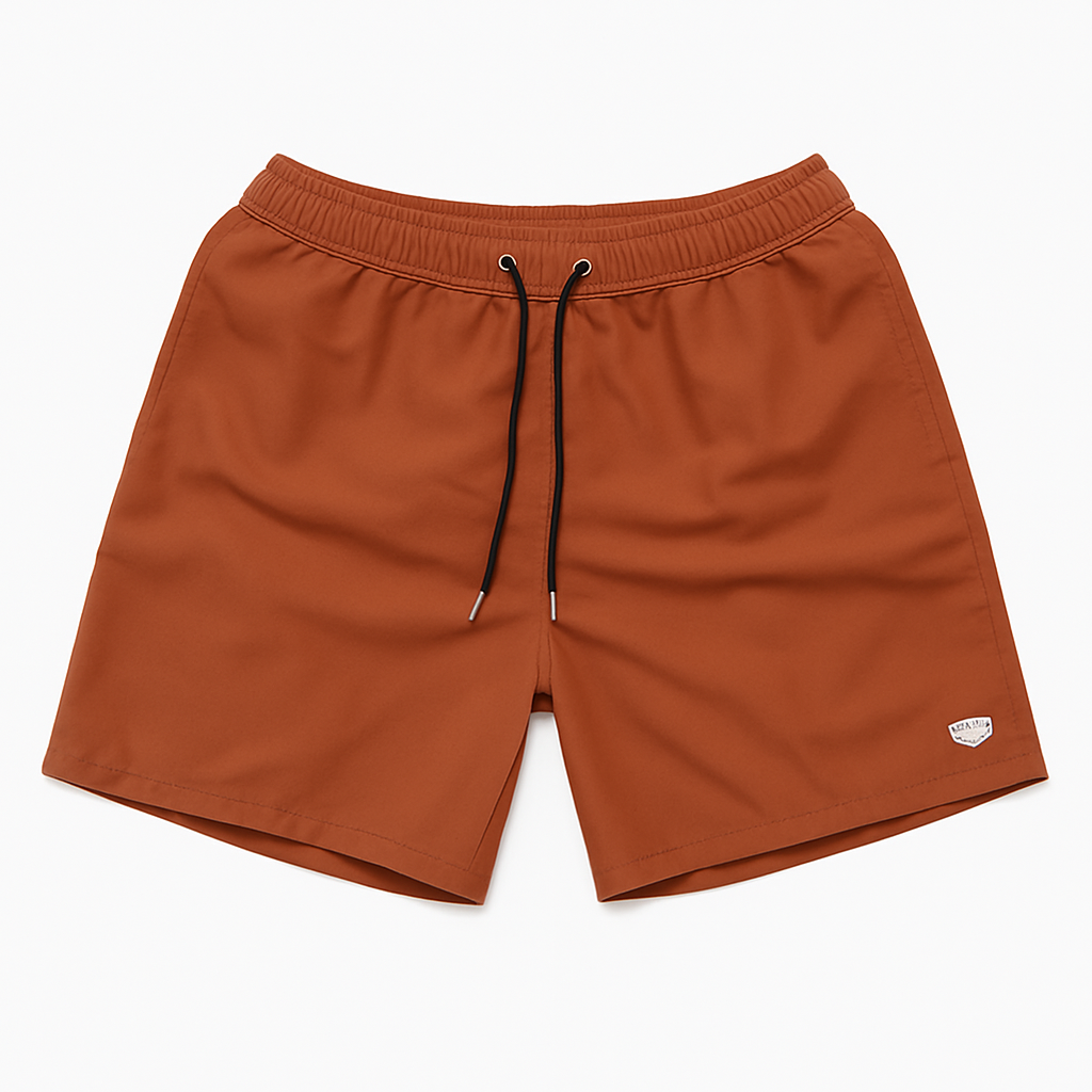 Flatlay of terracotta swim shorts with drawstring waist, displayed on a white background.